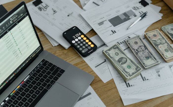 banknotes and calculator on table